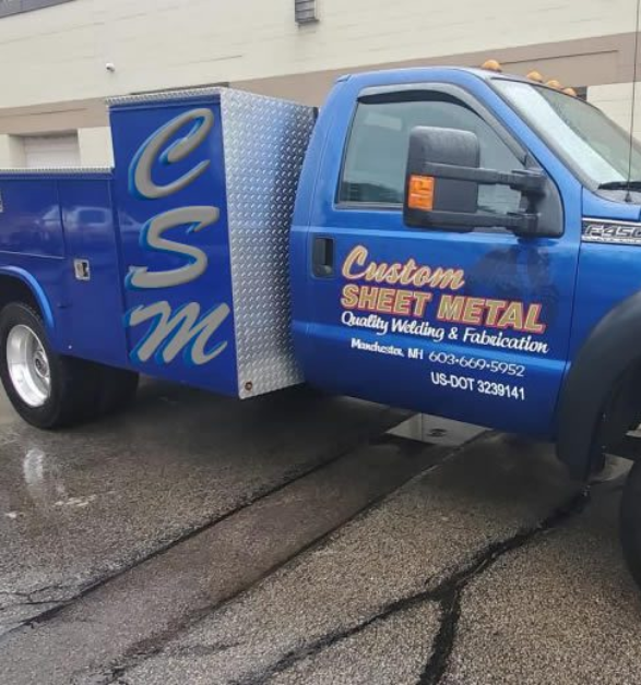 Custom Sheet Metal photo of a blue truck with company logo on it